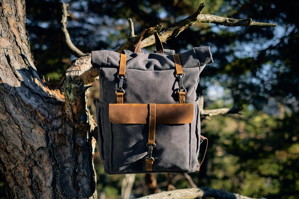 vintage hiking canvas backpack hanging down a tree ideal to store footwear. underwear. workwear or streetwear