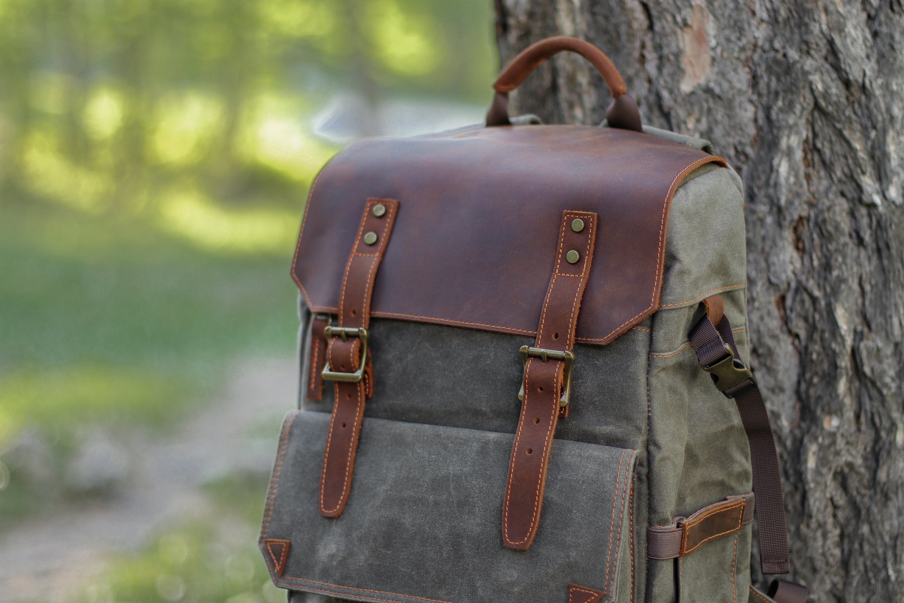 ripstop and watertight canvas and leather dslr camera backpack with sturdy webbing. zipper pulls