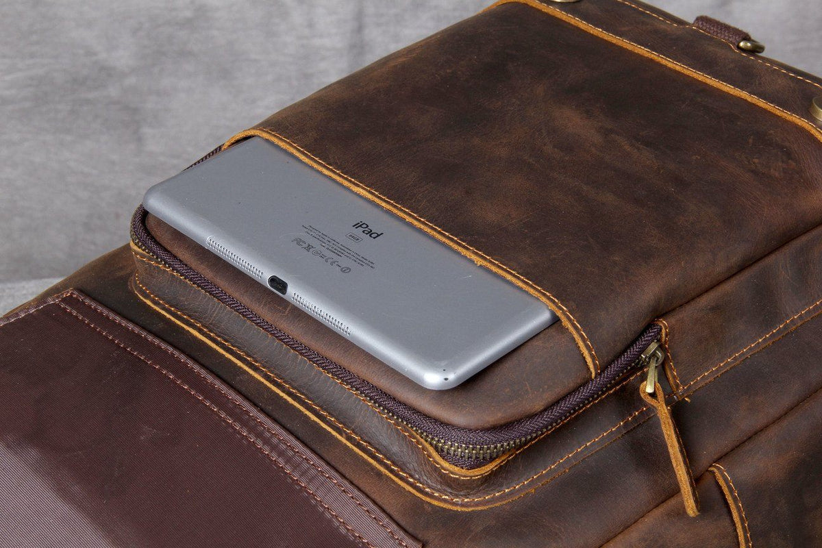 small brown leather garment-bag with zipped pockets to securely transport a wallet, a coin purse, a card holder or sunglasses