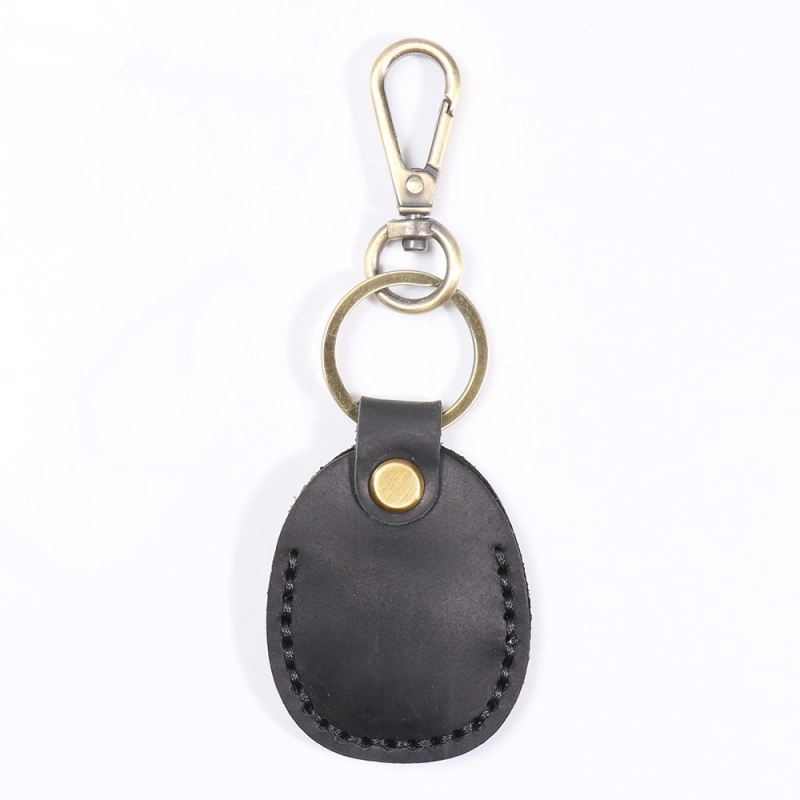 Black leather AirTag holder keychain with brass snap button