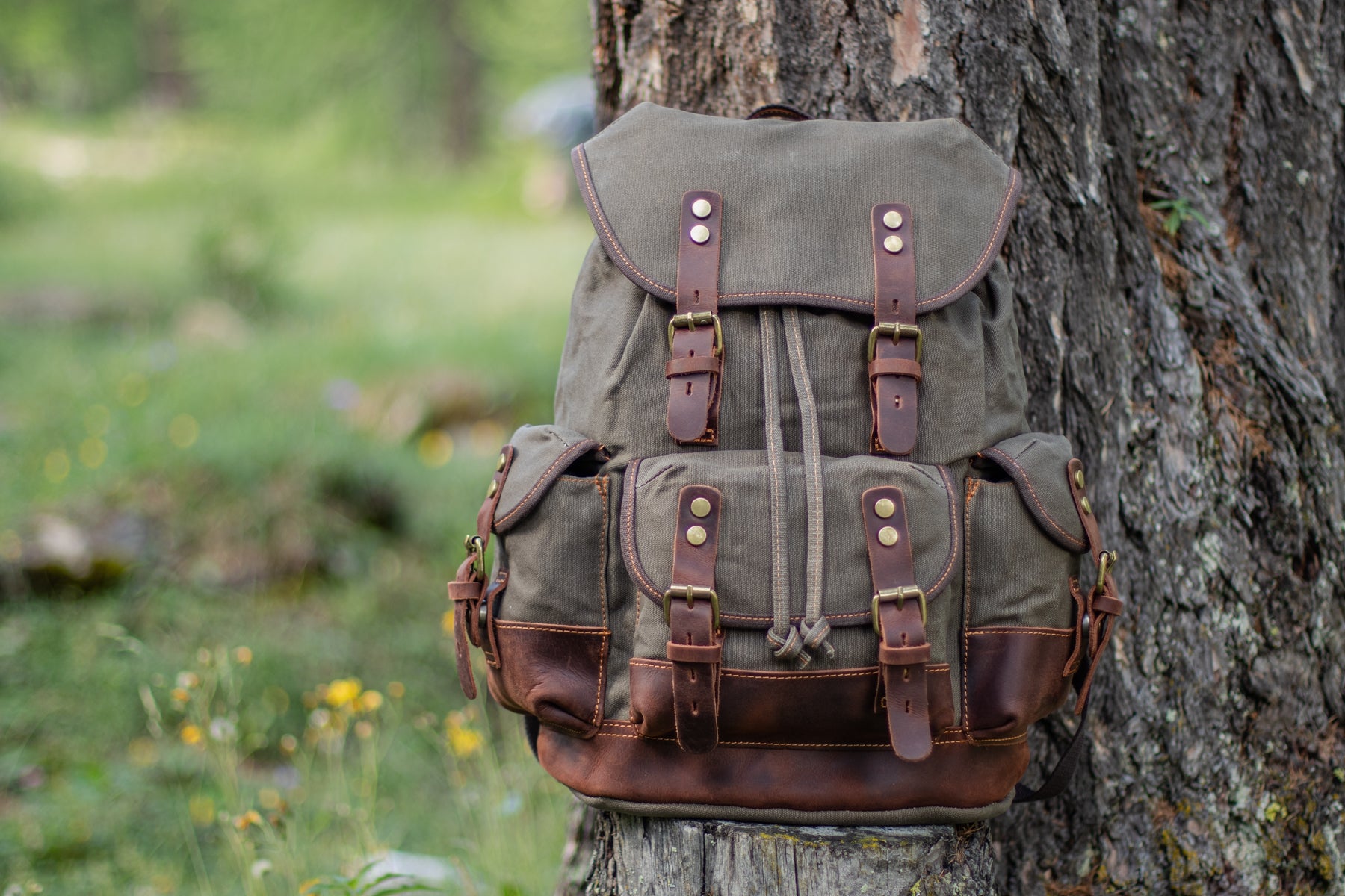 canvas hiking backpack shown from front and side angles