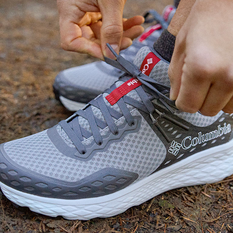 Close up shot of a person tieing the Konos laces