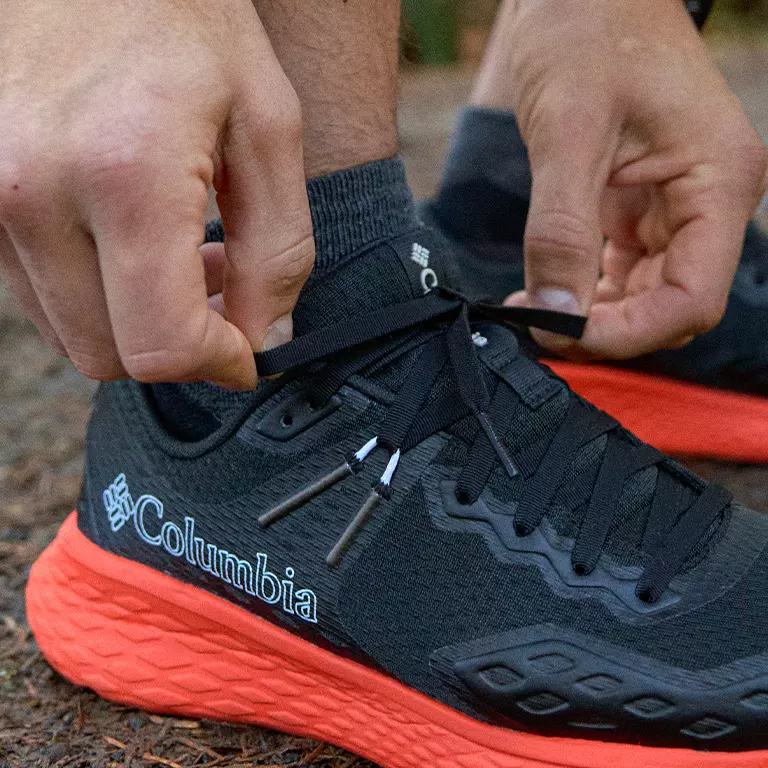 Close up shot of a person tieing the Konos laces