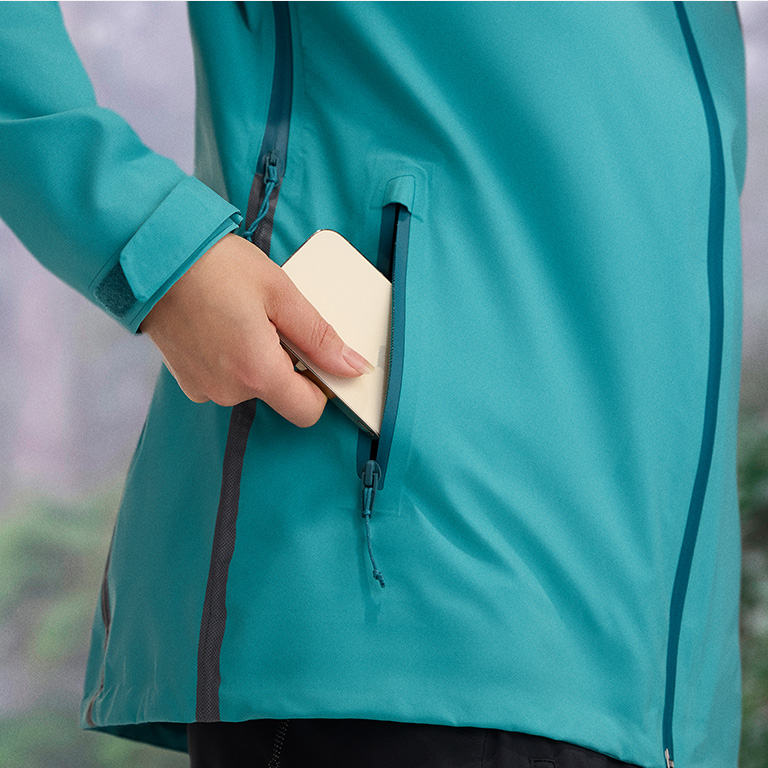 Close-up of a woman buttoning a Silver Ridge shirt. 