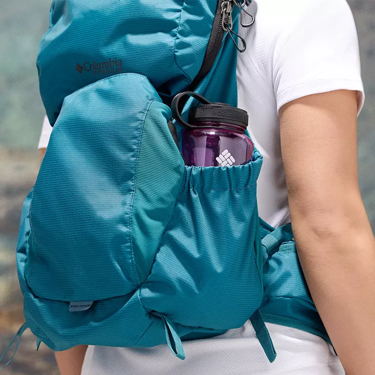 Close-up of a woman buttoning a Silver Ridge shirt. 