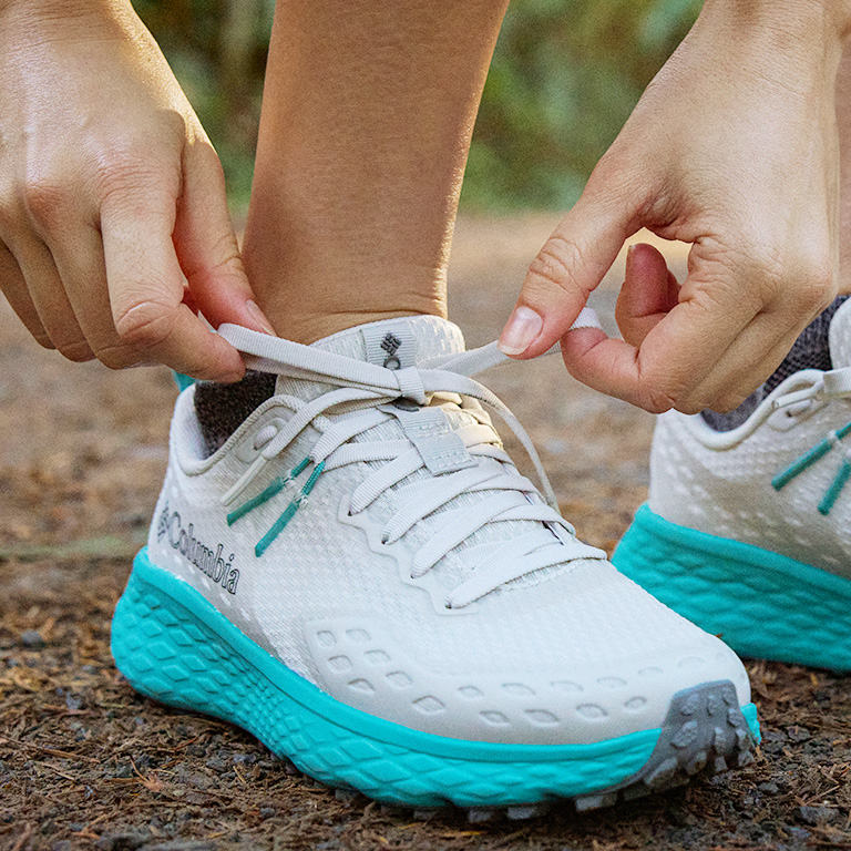Close up shot of a person tieing the Konos laces