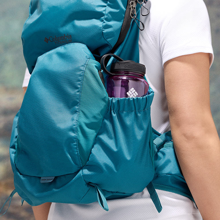 Close-up of a woman buttoning a Silver Ridge shirt. 