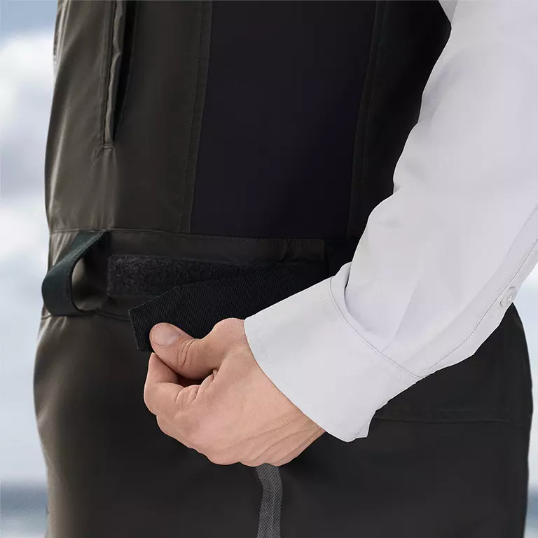Close-up of a woman buttoning a Silver Ridge shirt. 