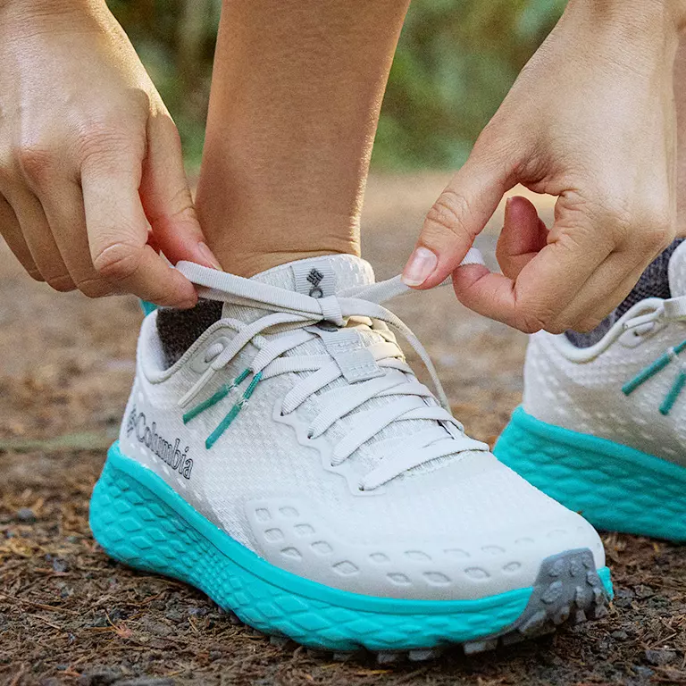 Close up shot of a person tieing the Konos laces