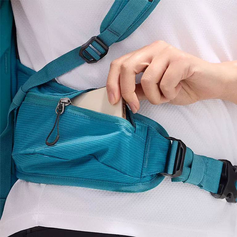Close-up of a woman buttoning a Silver Ridge shirt. 