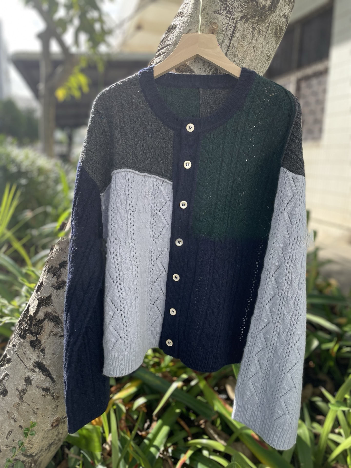Irregularly pieced together crew neck wool knit cardigan