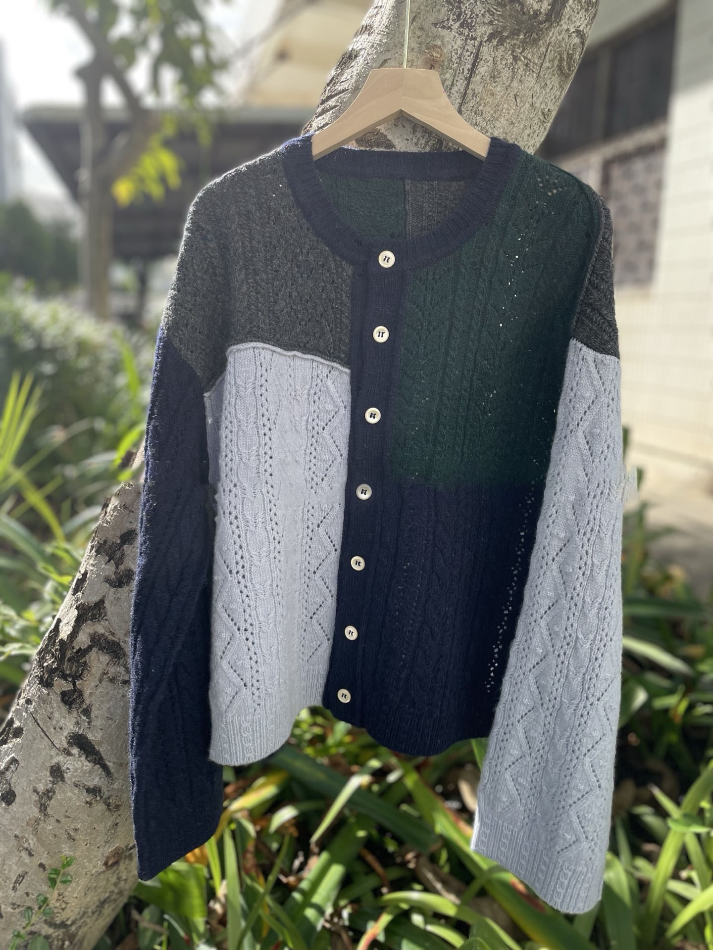 Irregularly pieced together crew neck wool knit cardigan