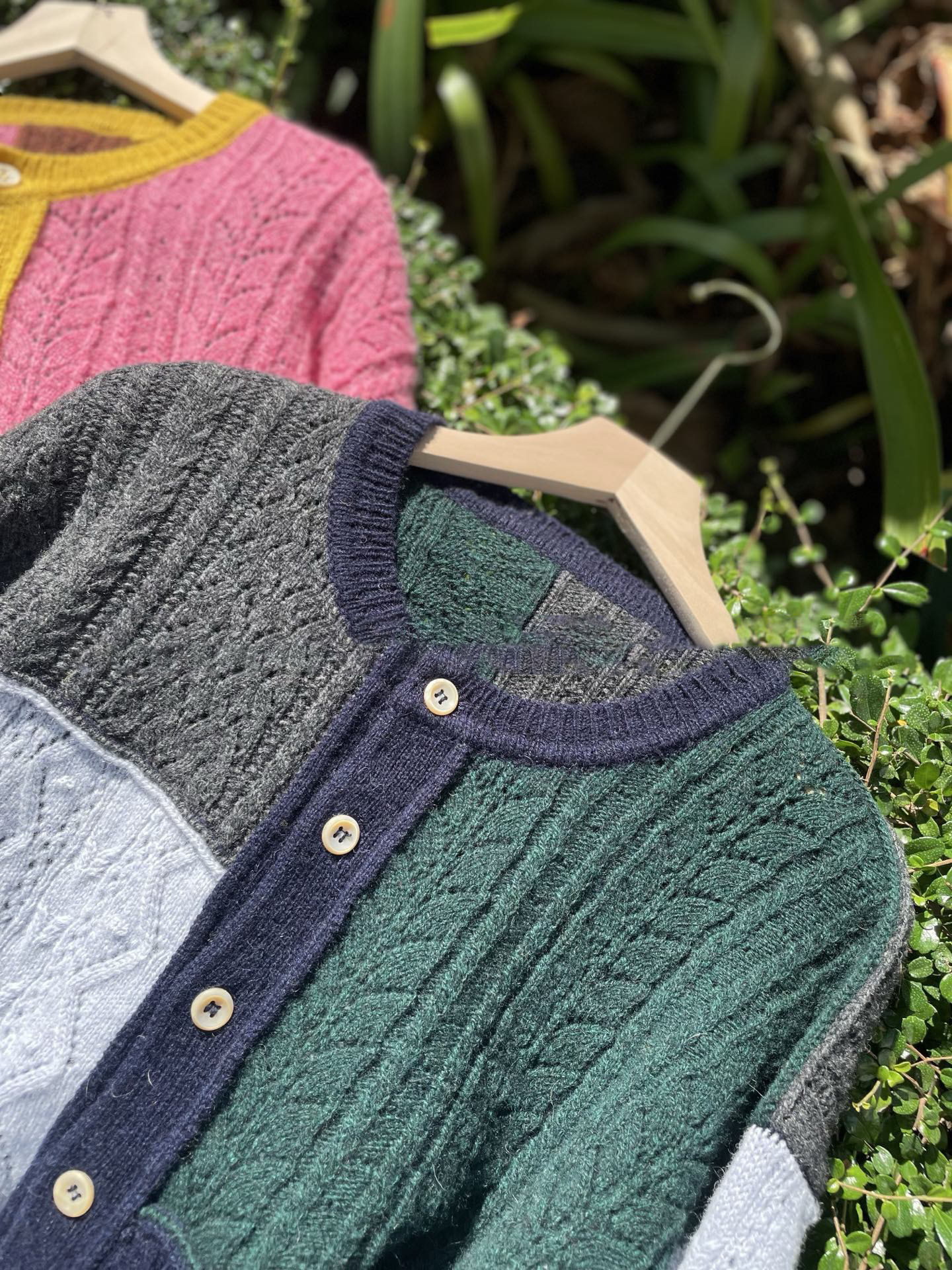 Irregularly pieced together crew neck wool knit cardigan