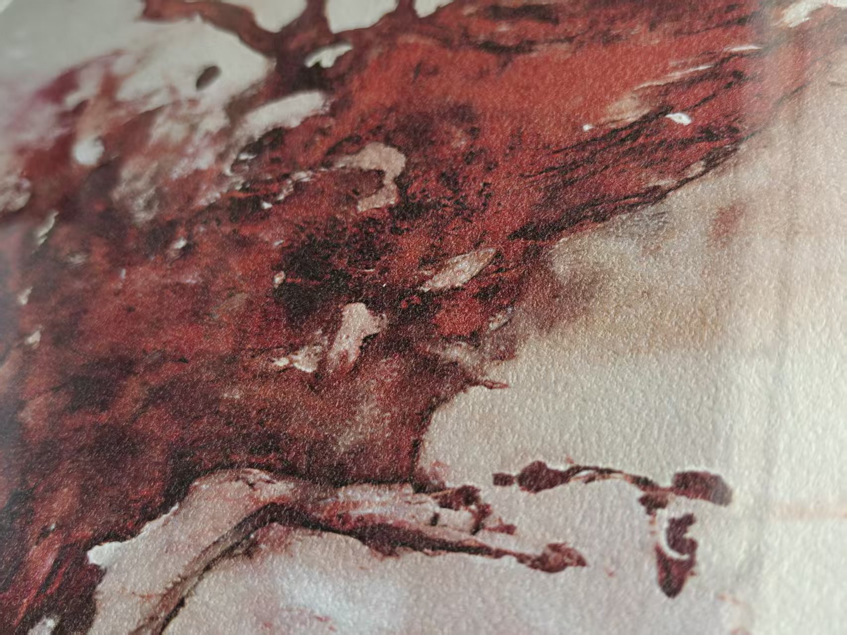 Even closer photograph of the red forms and textured print surface