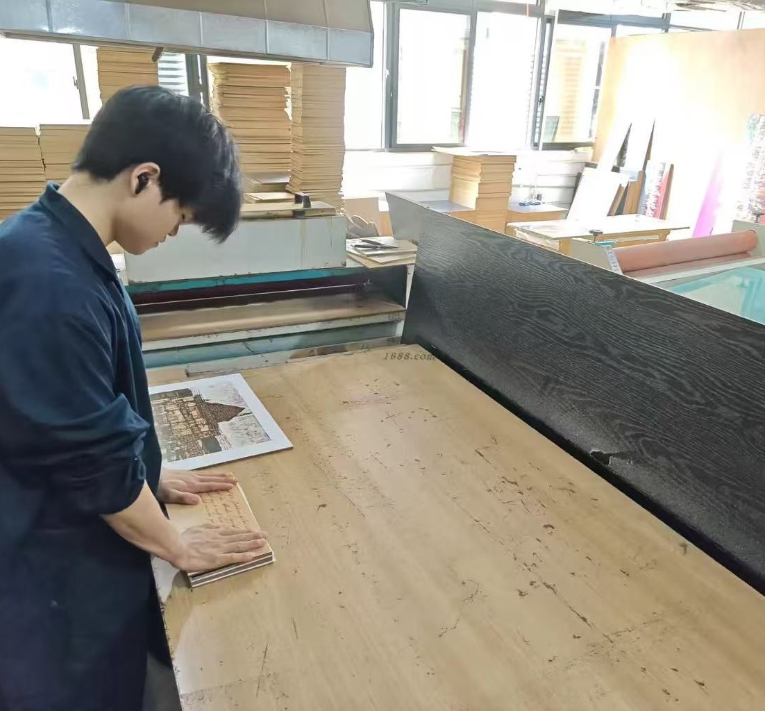 Workshop team member working at an adhesive application station