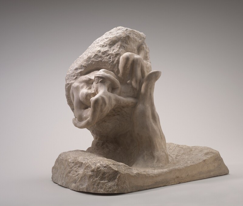 Plaster sculpture of a large hand holding two small figures, with smoother forms emerging beside a rough base.
