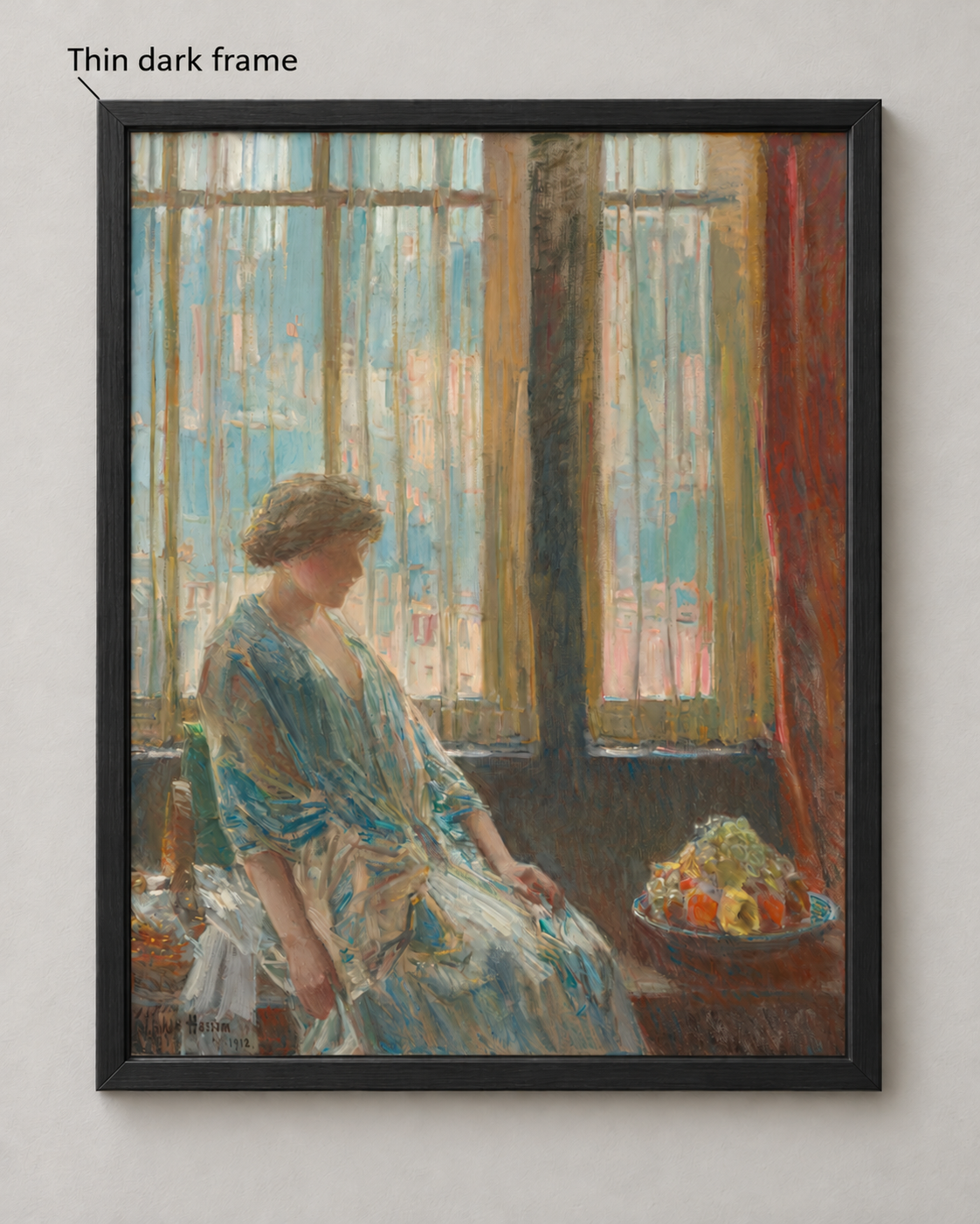Hassam’s woman-at-a-window image in a narrow dark wood frame with mitered corners and a small inner bevel on a pale wall.