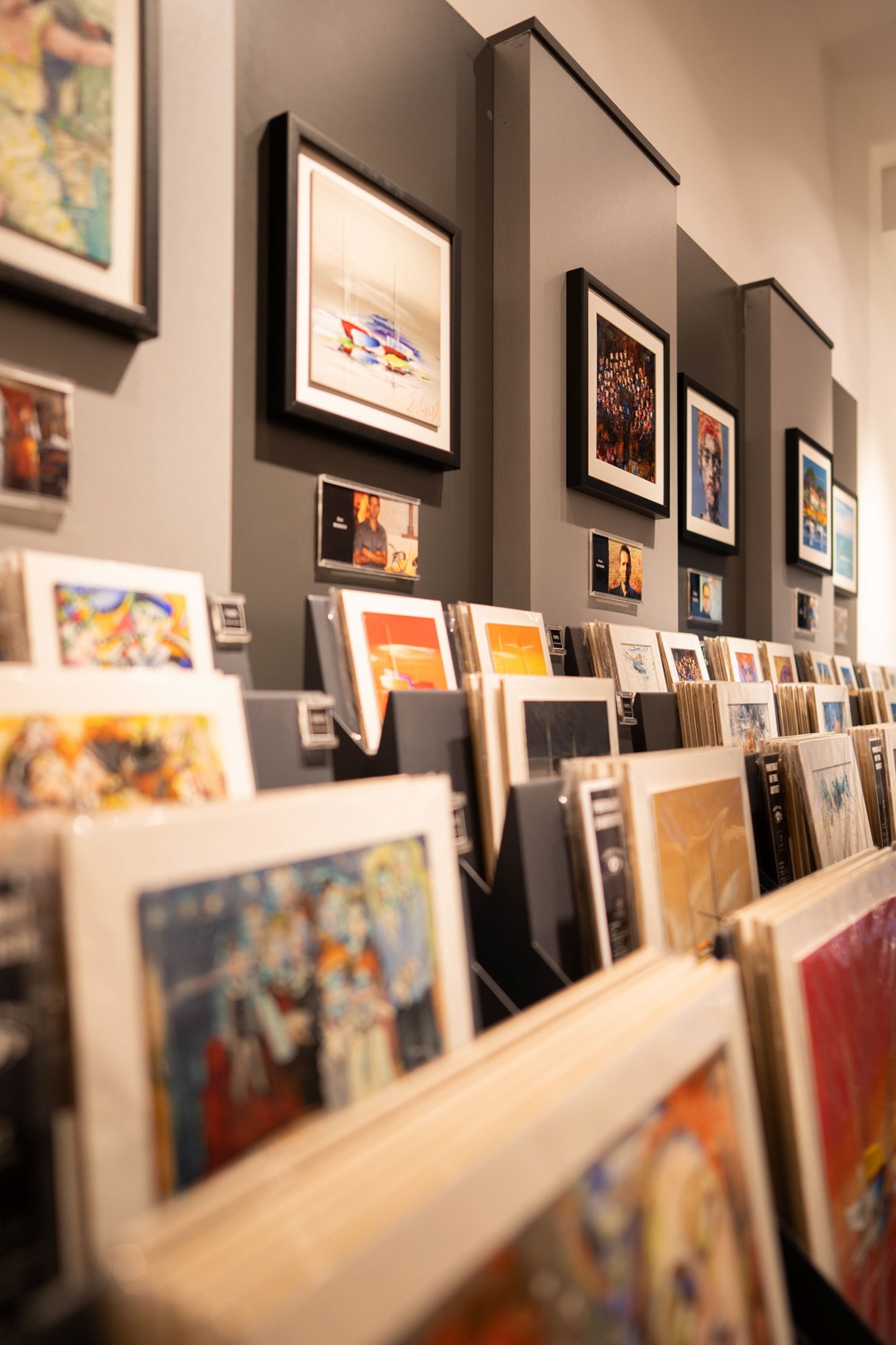 Framed graphic works displayed on a gallery wall.
