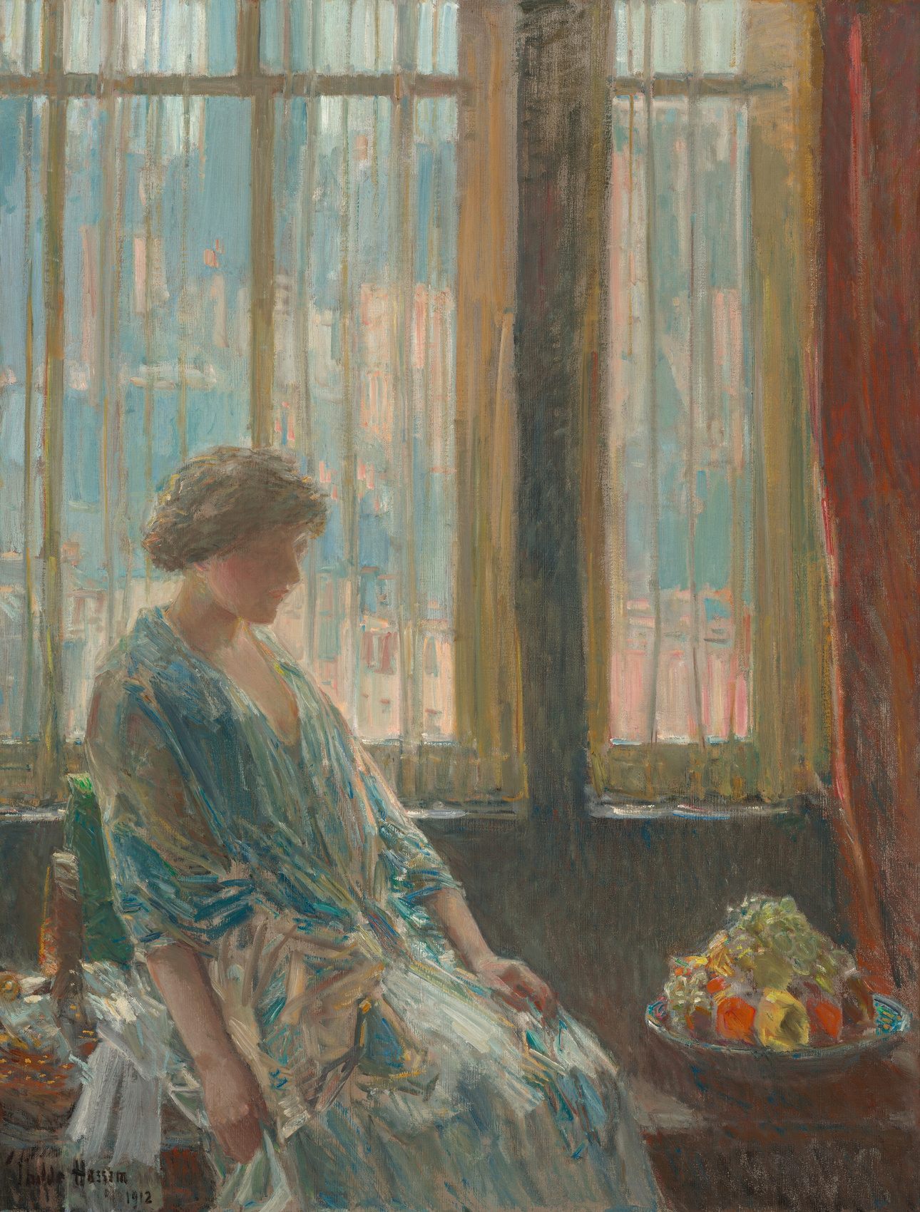 Woman in blue before luminous pale windows, with a dark lower edge and a red curtain at the right in Hassam’s The New York Window.