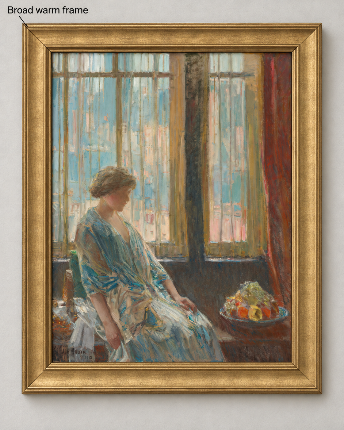 The Hassam image in a broad warm gold frame with a stepped profile, mitered corners and soft metallic highlights on a pale wall.