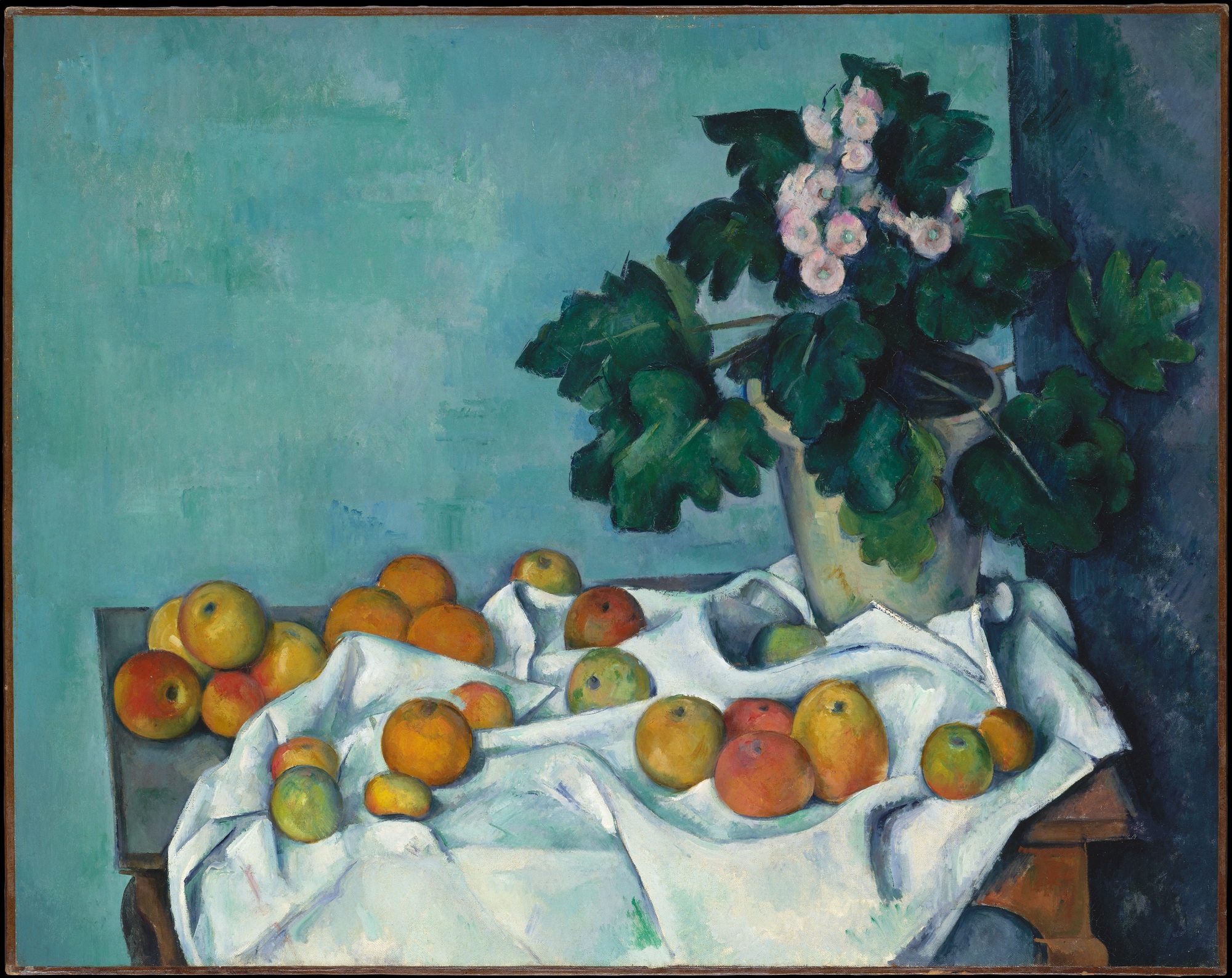 Red, yellow and green apples lie on a white folded cloth beside a pot of green primrose leaves and small pale blossoms against a blue-green background.