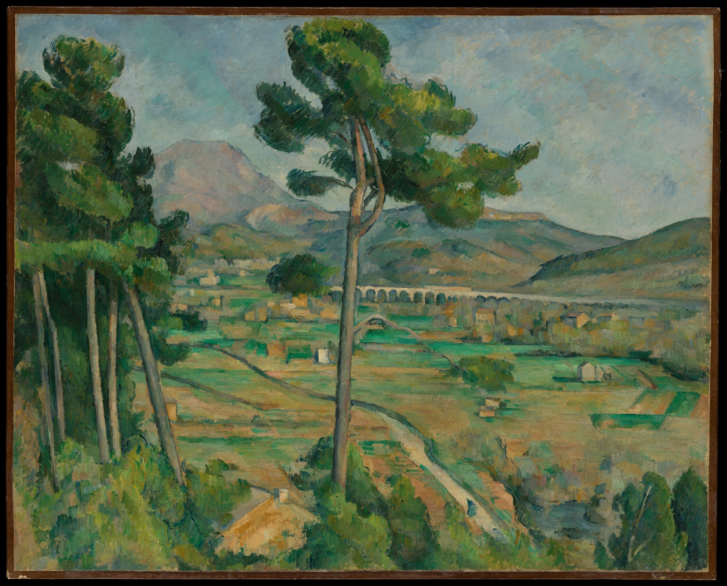 Tall foreground pines frame a distant mountain, pale viaduct arches and green and ochre fields.