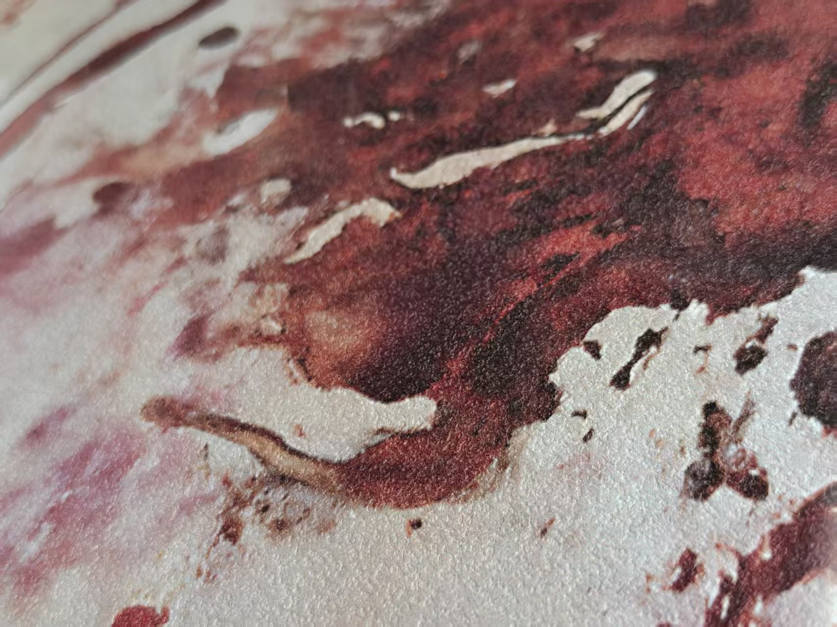 Close photograph of the same physical proof, showing red forms and the printed surface beside its mat