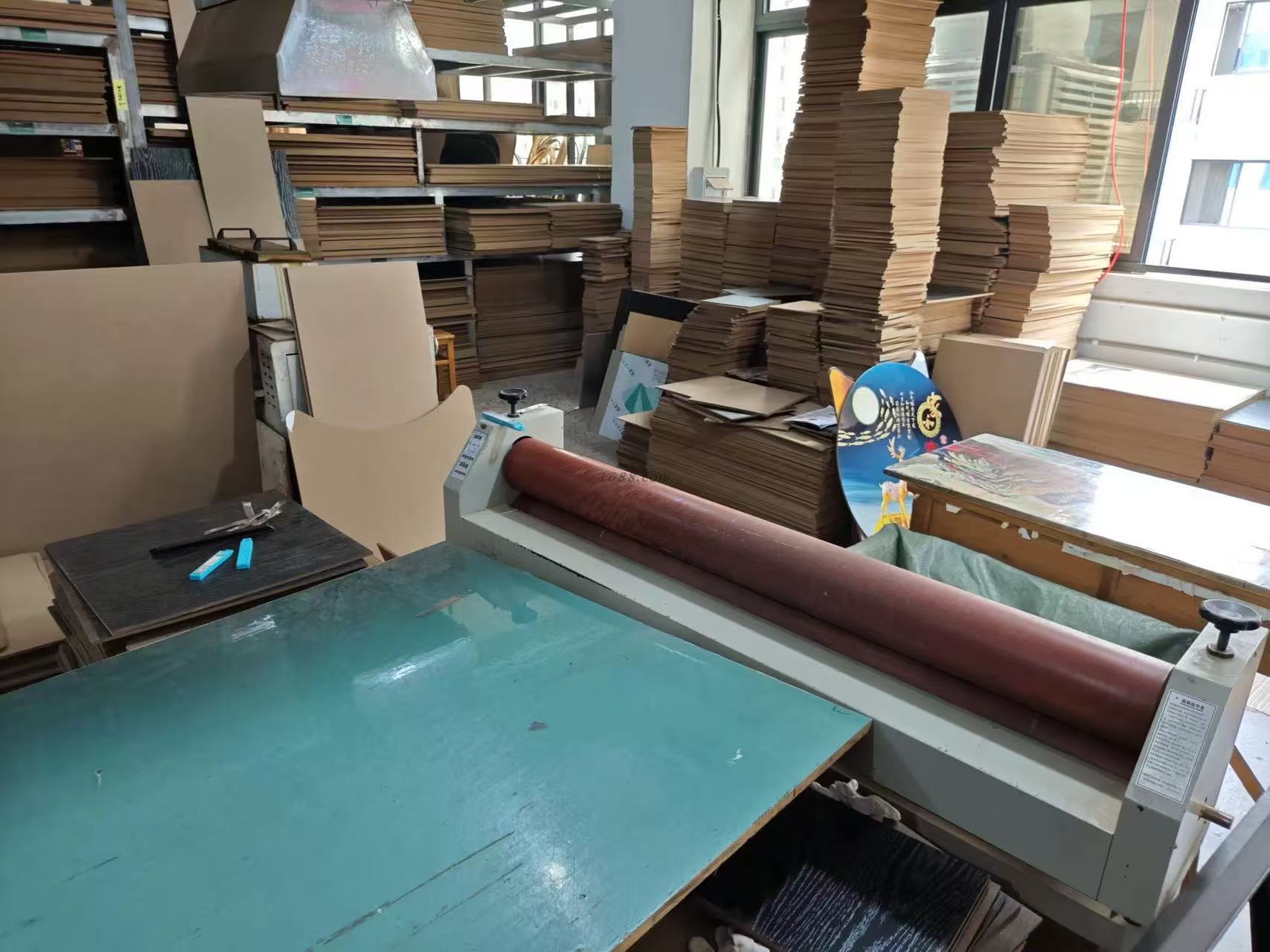 Cold-mounting press and prepared boards in the workshop