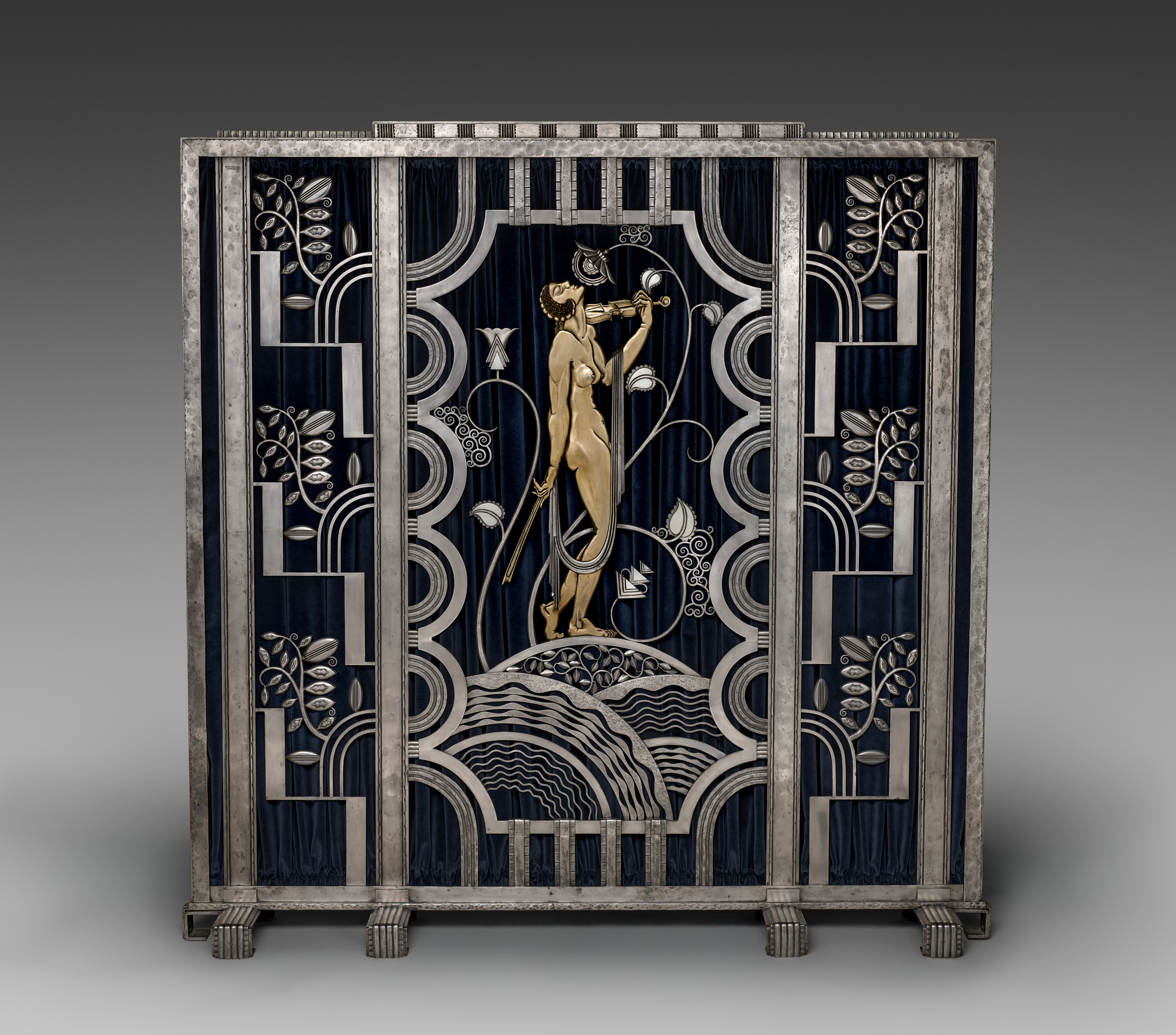 Paul Fehér's 1930 iron Muse with Violin Screen, with a central violinist, curving borders and stylized leaves.