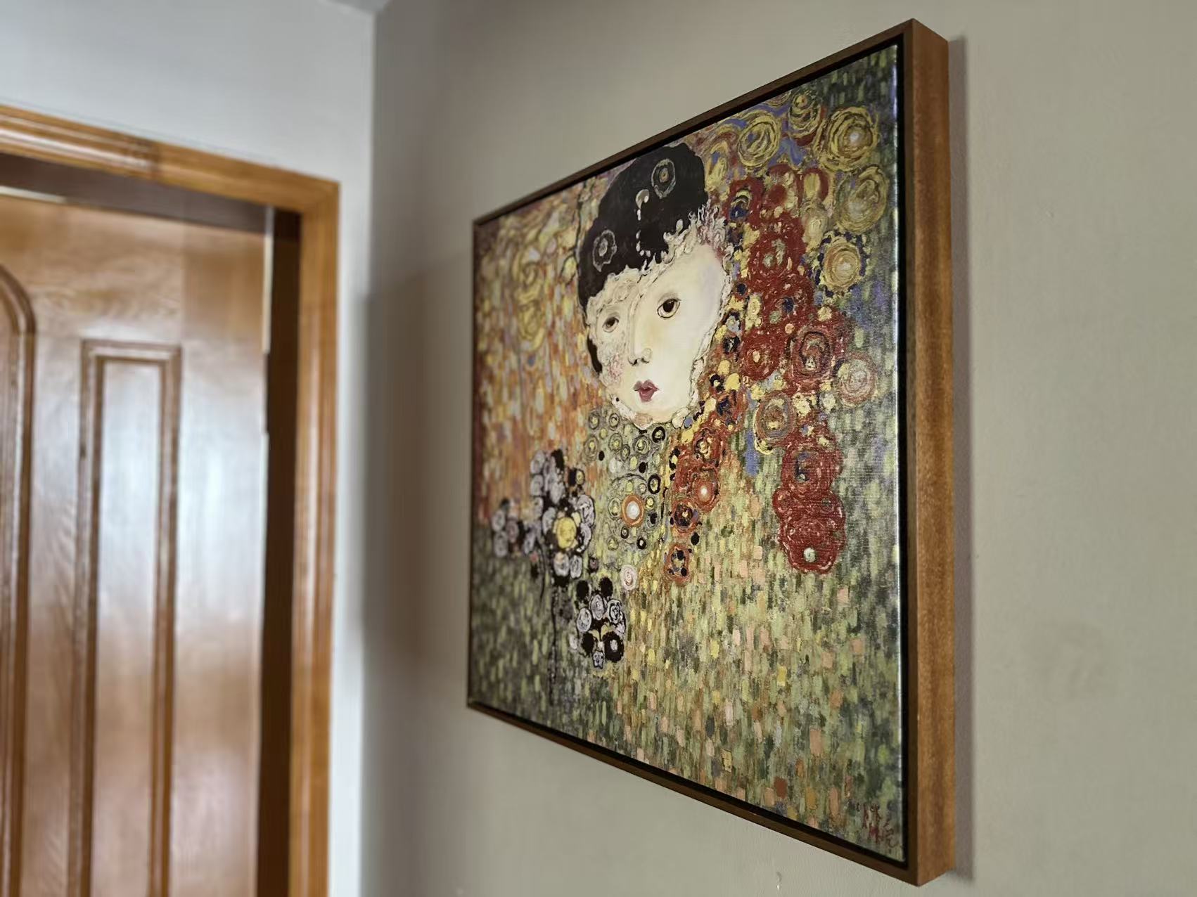 A verified framed Whispart artwork installed beside a wooden doorway in a real interior