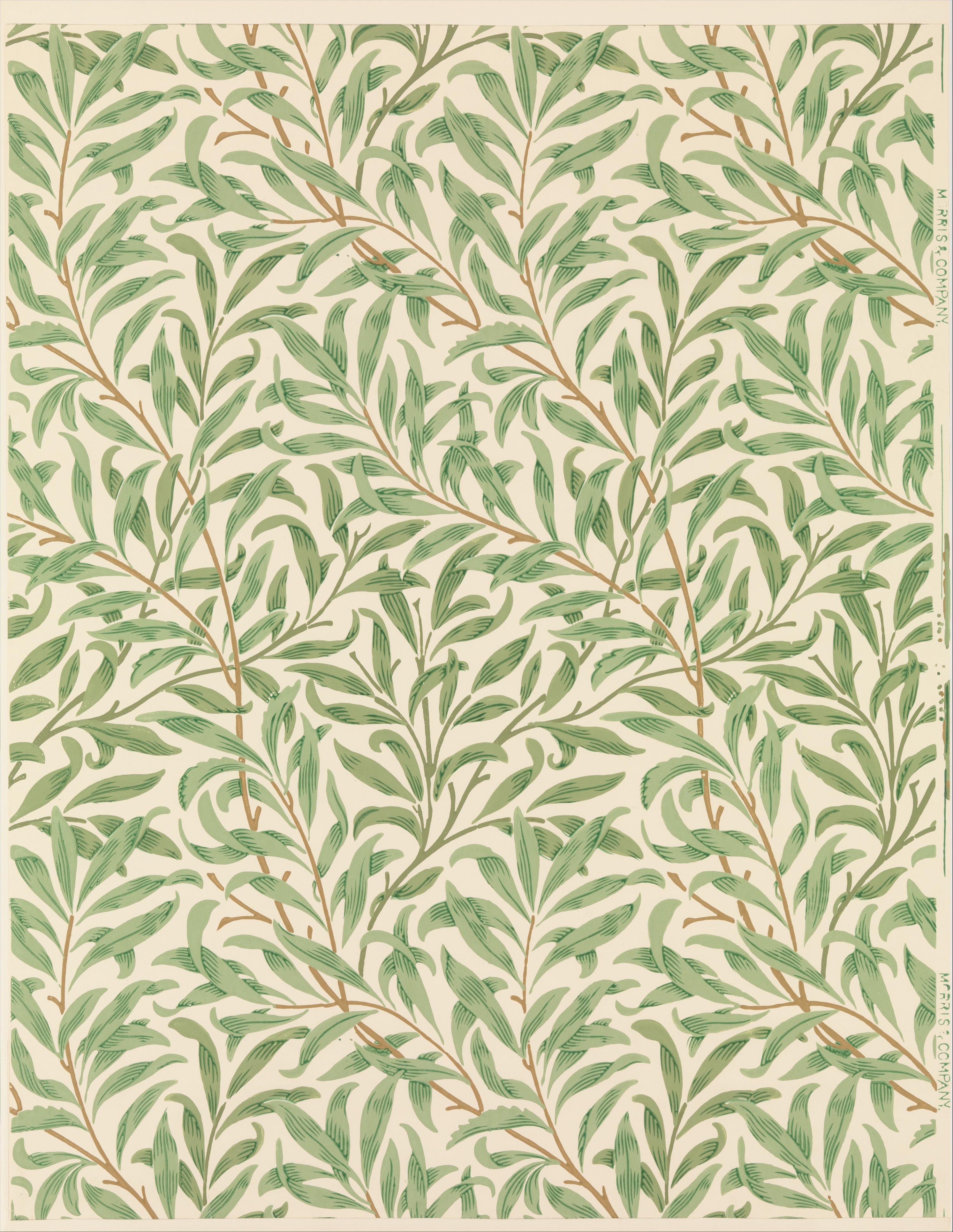 Repeated narrow green leaves and interlaced brown stems on the cream ground of William Morris’s Willow Bough wallpaper.