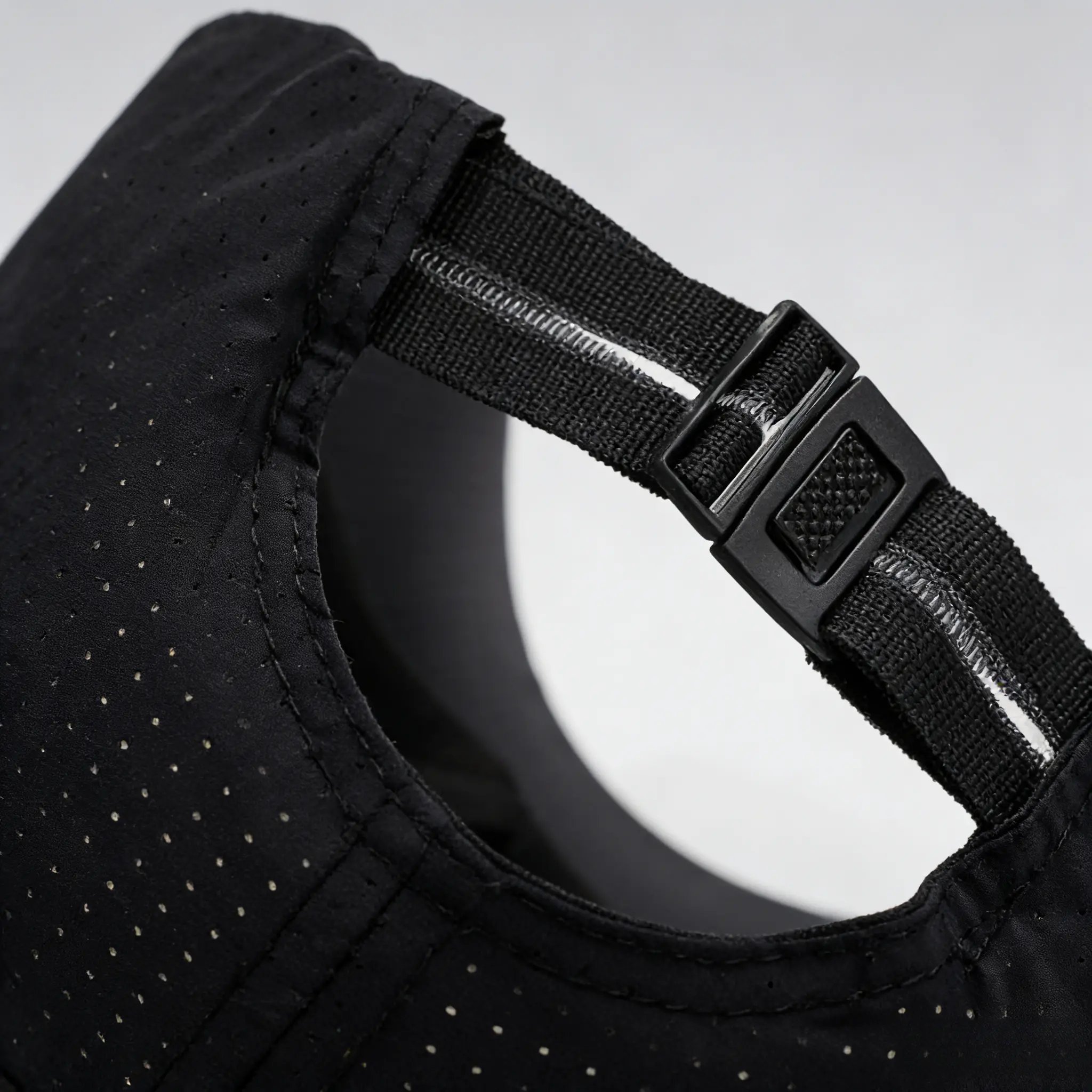 Close-up of adjustable rear strap on black cap