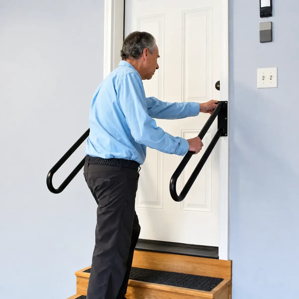 Father using secure handrails at his doorway