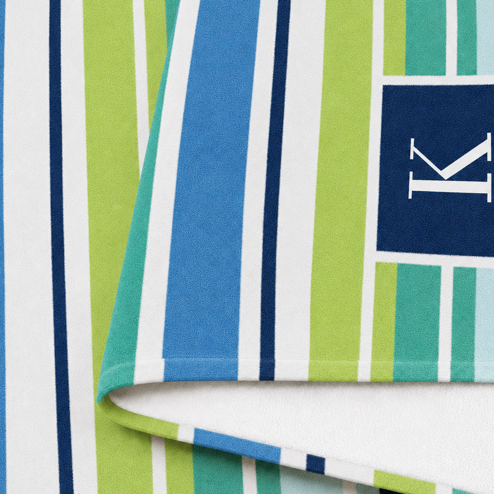 Personalized striped beach towel made with soft microfiber fabric featuring custom monogram design
