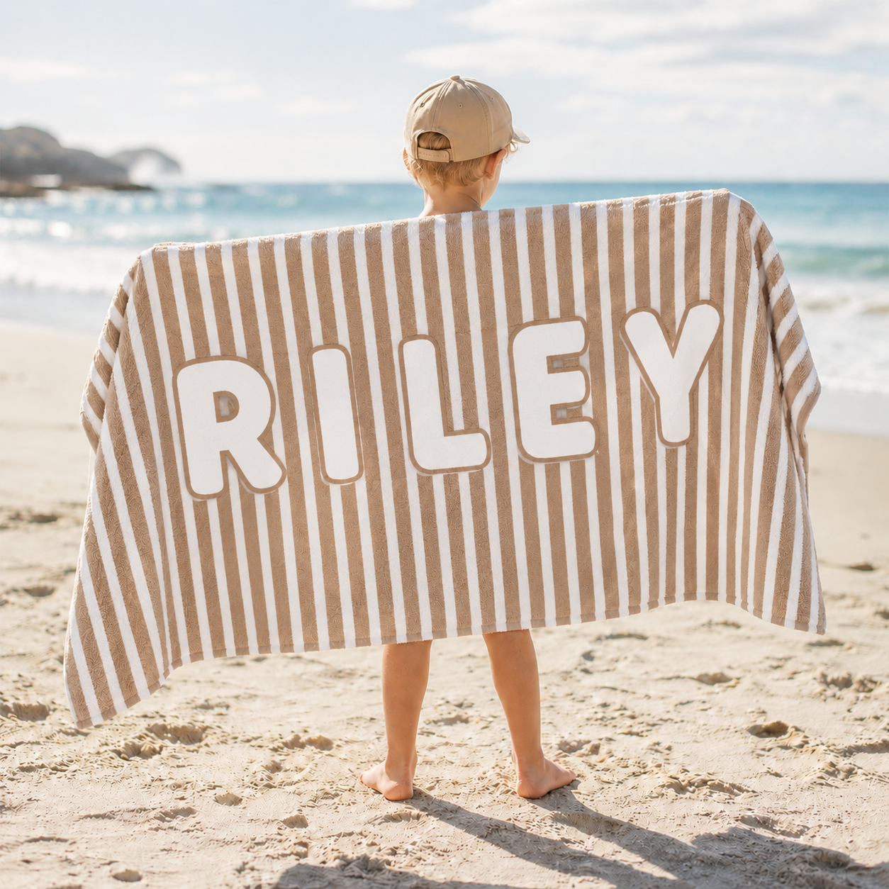 Custom name kids beach towel used by children at the beach for summer vacation and outdoor activities