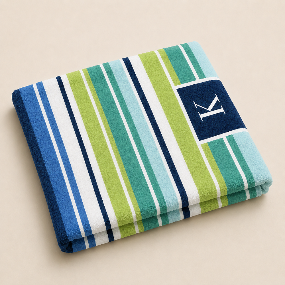 Folded personalized beach towel showing soft fabric texture and custom monogram detail