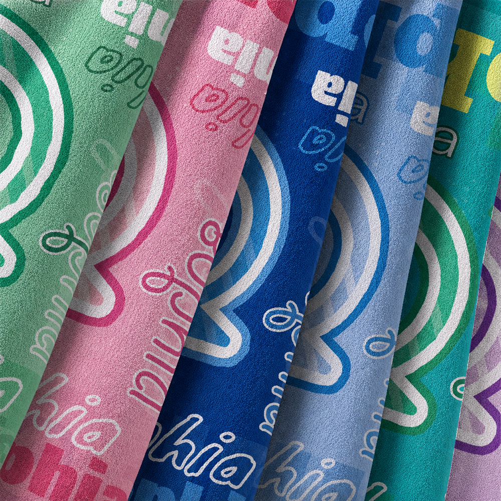 Colorful personalized initial and name beach towels with close up view of soft fabric texture and custom designs