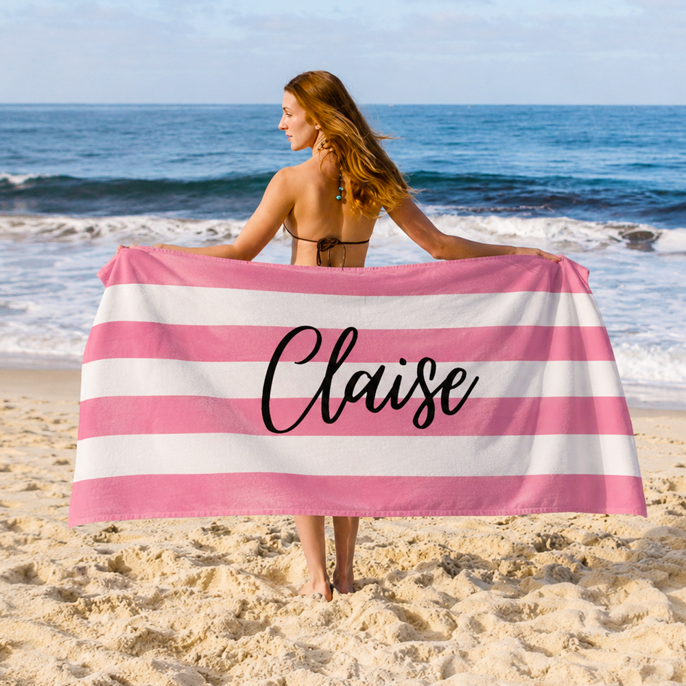 Personalized name beach towel used for relaxing outdoors with custom striped towel design