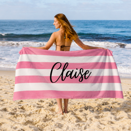 Personalized name beach towel used for relaxing outdoors with custom striped towel design