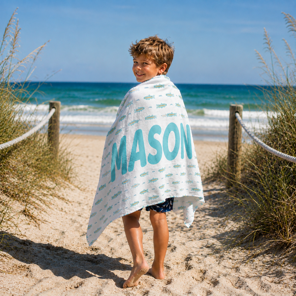 Personalized kids beach towel featuring custom name and fish pattern design for beach trips
