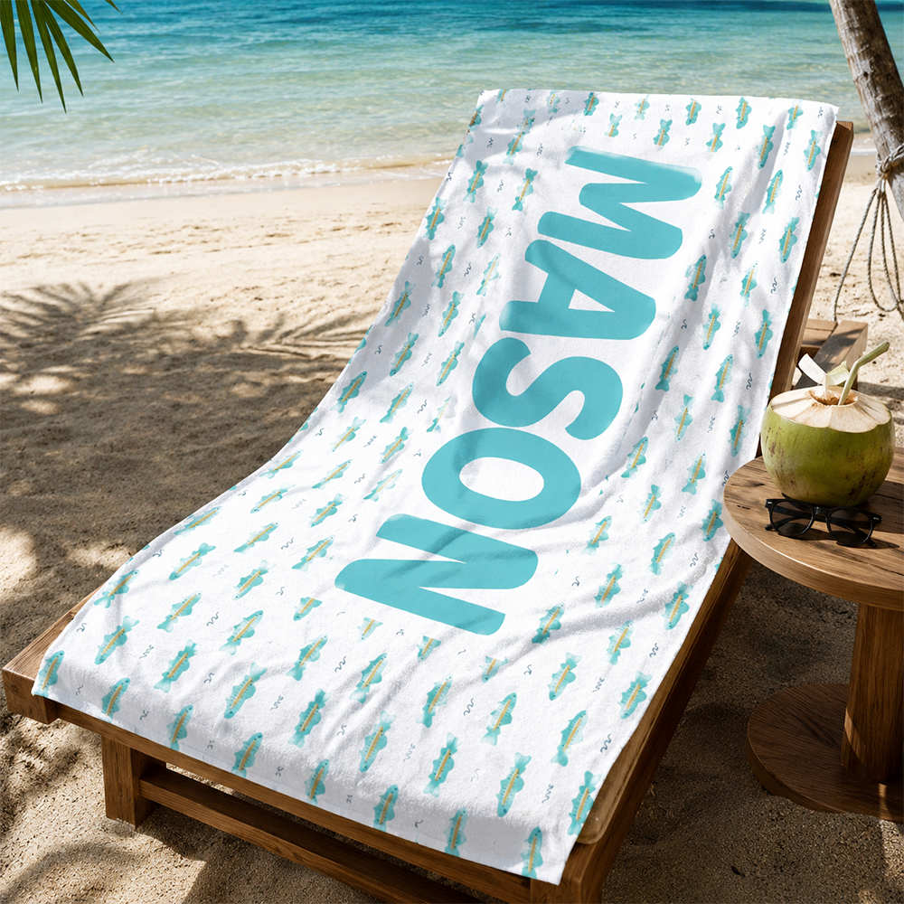 Custom personalized kids beach towel displayed at a poolside lounge for summer beach vacations