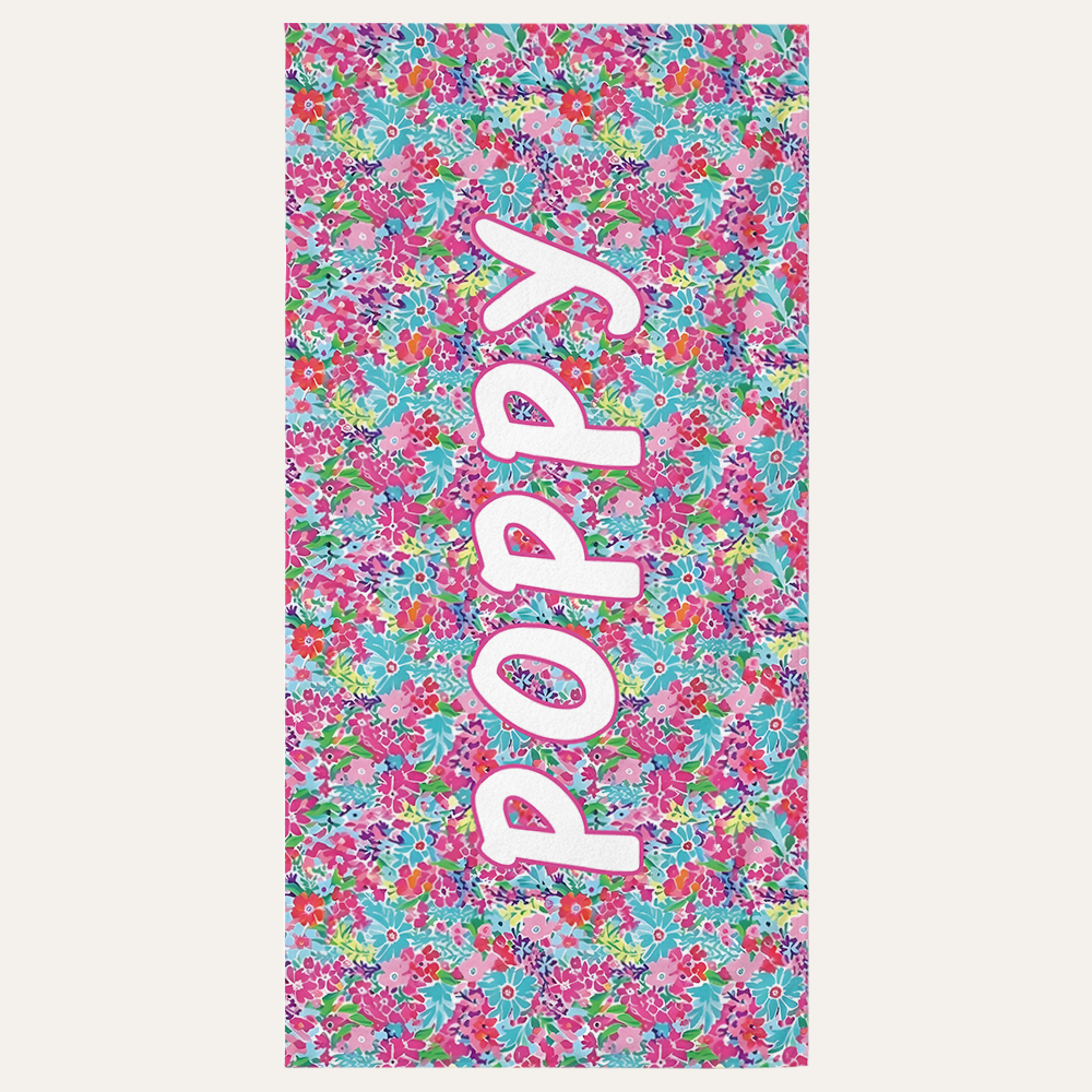 Personalized kids beach towel with custom name and floral petal design for beach and pool use
