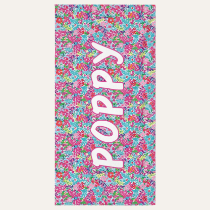 Personalized kids beach towel with custom name and floral petal design for beach and pool use