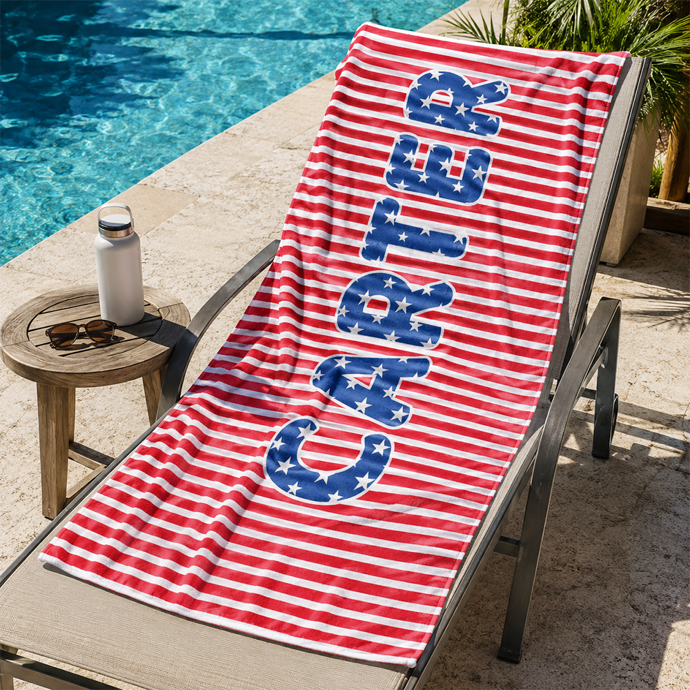 Custom personalized kids towel displayed at a poolside lounge area for beach vacations