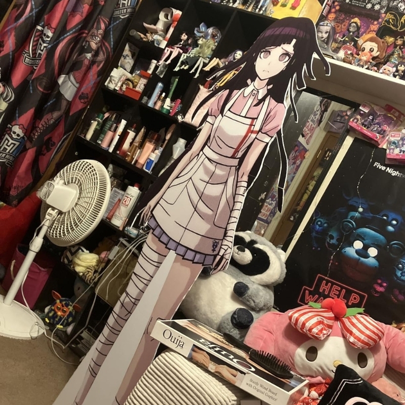 Anime girl character life-size cutout in pink nurse outfit displayed in decorated bedroom