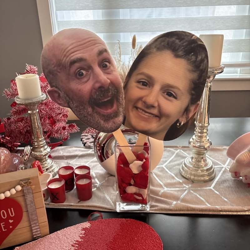 Romantic table setup with couple big head cutouts in vase for anniversary celebration