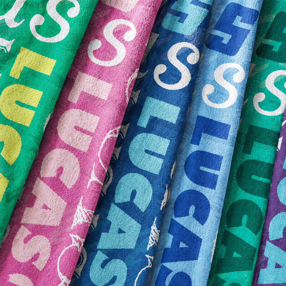 Close up view of personalized name pattern beach towel with colorful print and soft microfiber texture