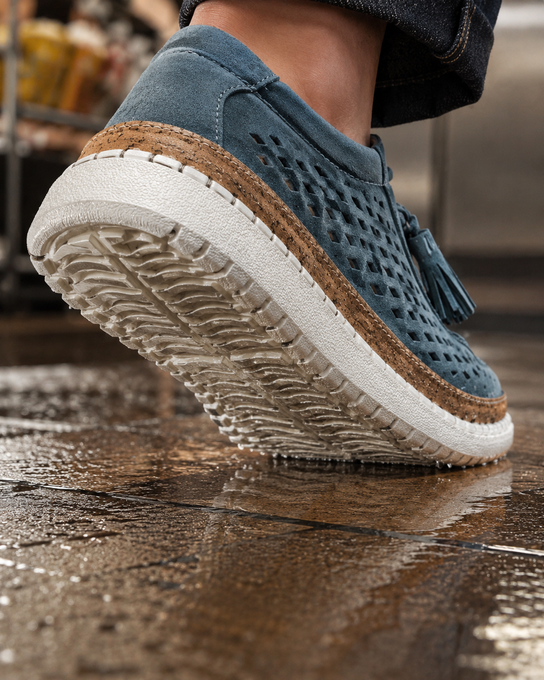 Suggested image: outsole tread close-up of the sneaker stepping on wet supermarket tile or a damp caf&eacute; entrance floor, showing textured grip pattern