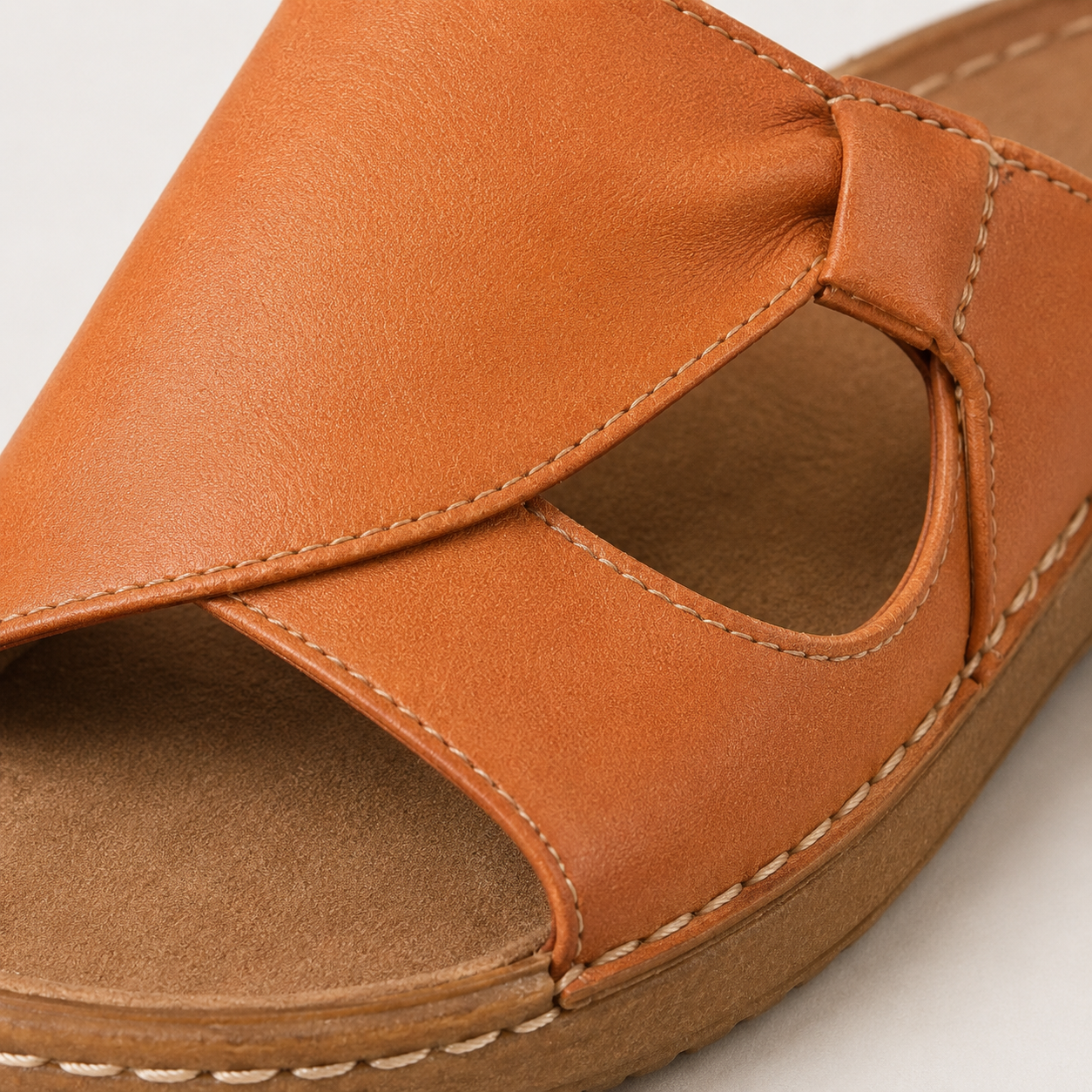 Suggested image: macro close-up of soft leather-look upper texture with clean stitching or smooth finish, no brand watermark