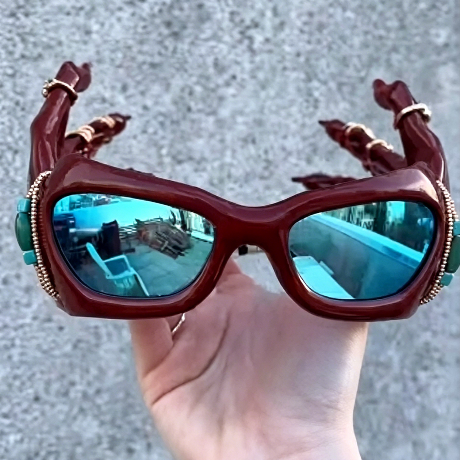 3D-printed red hand-shaped sunglasses